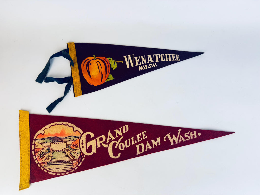 Two vintage-style pennants with scenic designs and text on a white background