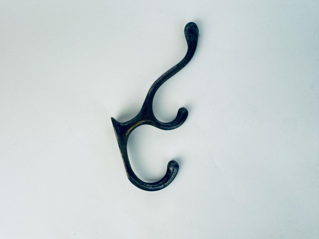 Black metal double hook on a white background