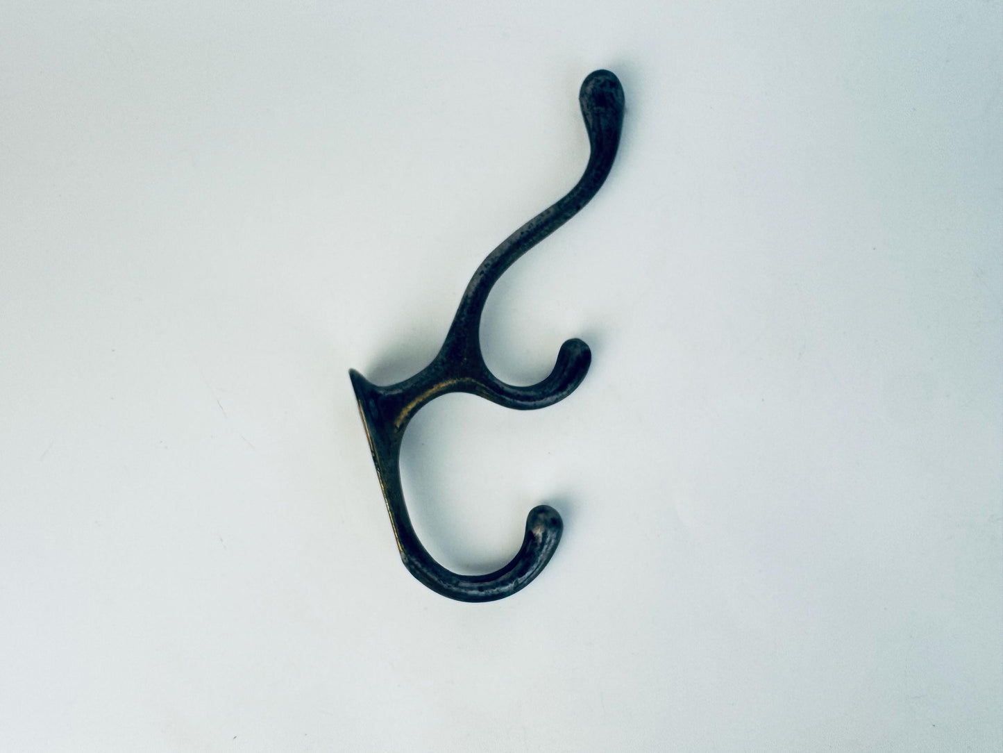 Black metal double hook on a white background