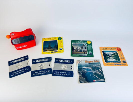 Collection of View-Master reels and a red View-Master device on a white background