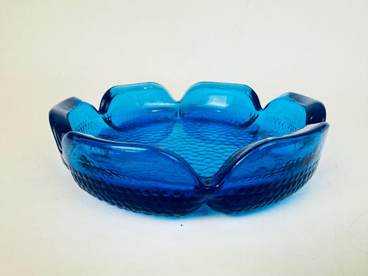 Blue glass bowl on a beige background