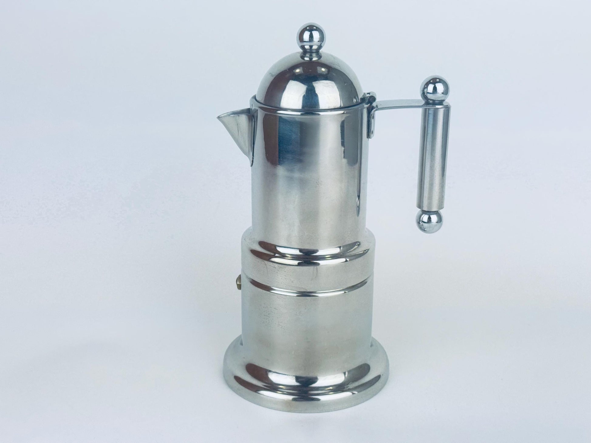 Chrome Vev Viganò Kontessa stainless-steel moka pot with dome lid and straight cylindrical handle on white background.