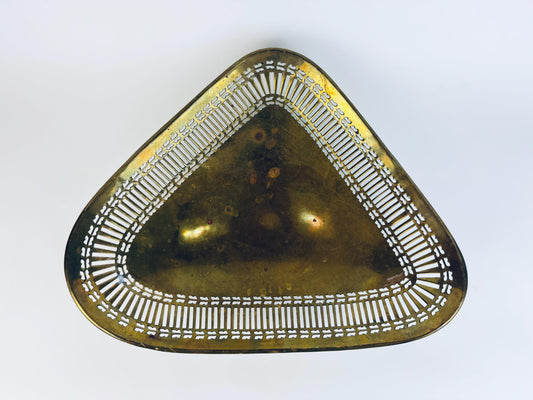 Vintage triangular brass tray with pierced openwork edging and a gently rounded triangular shape, shown from above against a white background.