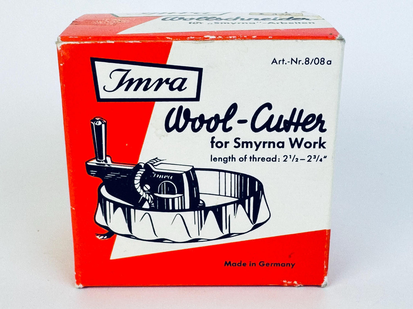 Front view of a vintage Imra Wool-Cutter box from the 1950s, featuring bold red and white mid-century graphics, black illustrated cutter artwork, and “Made in Germany” printed at the bottom.