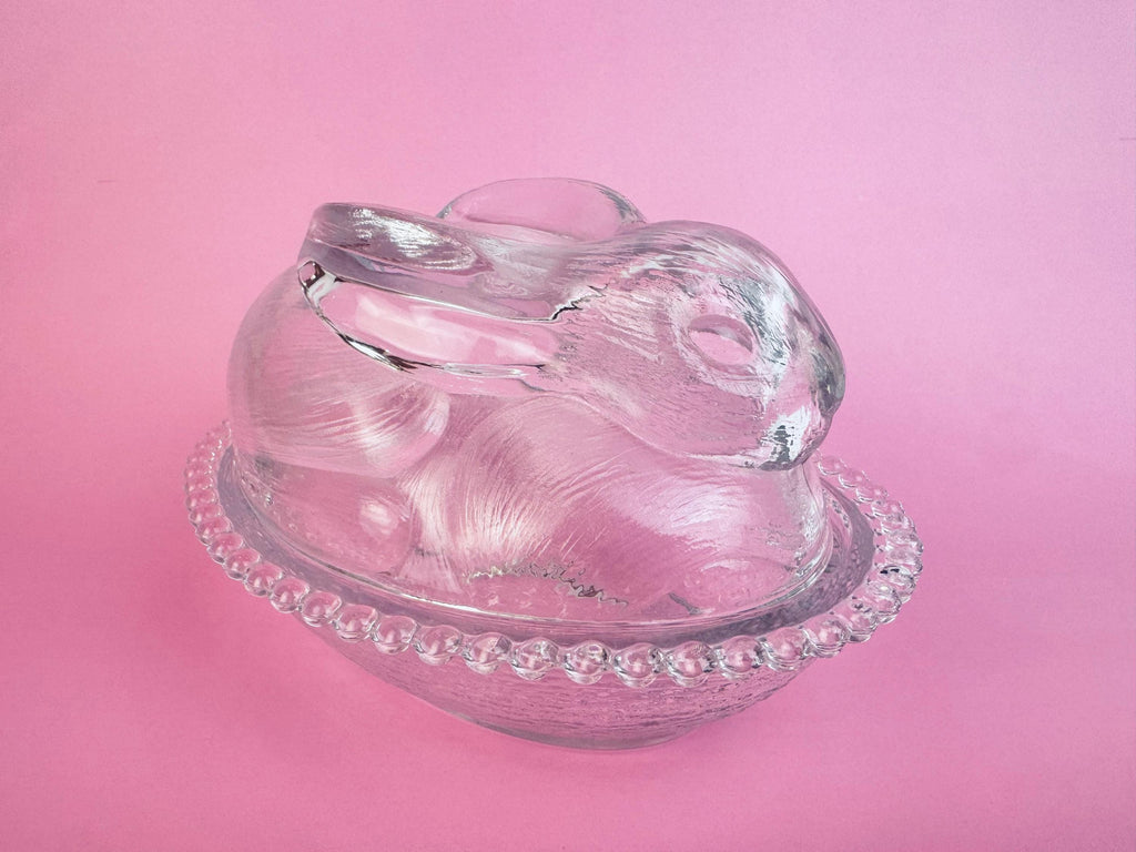 Clear pressed-glass bunny-on-nest covered dish with beaded rim, 1970s collectible.